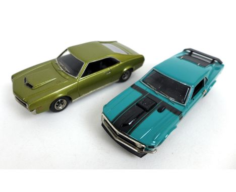 Two Boss die cast 1/43 scale model cars, a 1970 Ford Mustang in green, with detachable wing mirrors, and a No. 2 1970 AMC Jav