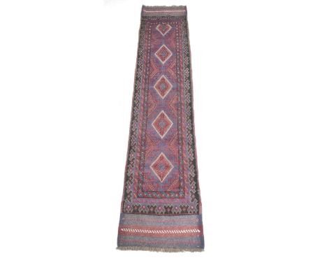 A Meshwari runner, with red and blue geometric ground, five diamond medallions, black edges, and striped ends, 255 by 57cm. 
