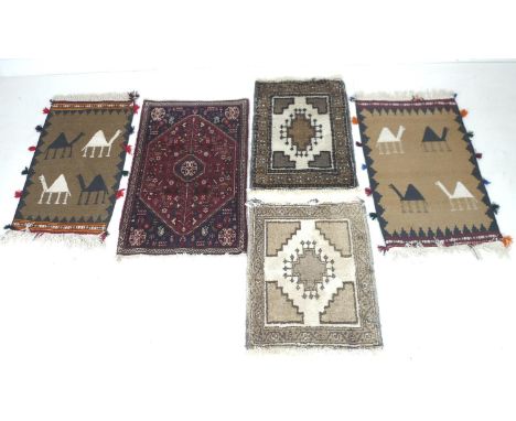 A group of five prayer rugs, comprising three Iranian wool, and two flat weave with camel motifs. red carpet 99 by 64cm, came