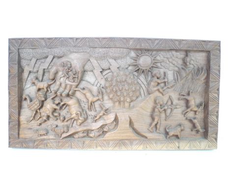 A group of Malawian wooden carvings, comprising two of rectangular form, one depicting the creation story, the other with var