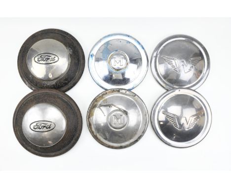 Two classic Ford car hub caps, together with two Morris Minor and two Wolseley hub caps, circa 1950/60s, Ford caps 25.5 cm di