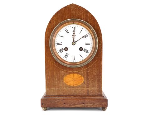 An Edwardian mahogany mantle clock, of lancet form having a drum movement striking on a gong, the case front having marquetry