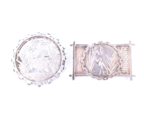 Two Victorian silver Aesthetic Movement influenced brooches, each decorated in depiction of a pelican or similar bird amongst