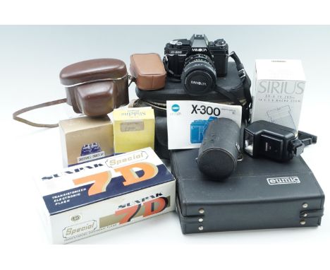 A Minolta X300 35 mm SLR camera with 35-70 mm zoom lens and a boxed 70-200 mm macro zoom lens, flash, light meter, etc, toget