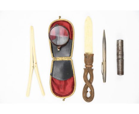 A Victorian bone glove stretcher, a carved wood and bone paper knife, a purse with folding faux-tortoiseshell pocket magnifyi