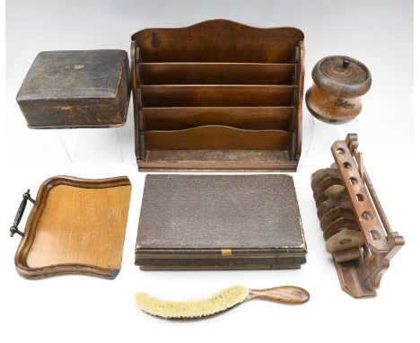 A 1930s oak crumb tray and brush, a tea caddy, racks for stationary, toast, and pipes, together with an early 20th Century le