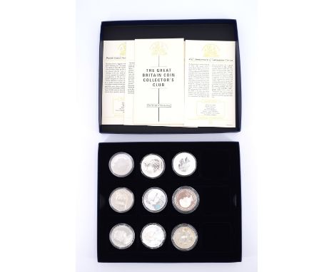 Nine QEII commemorative silver £5 and 1oz proof commemorative coins