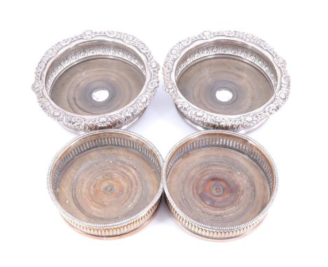 Two pairs of late Georgian / Victorian silver plated decanter coasters, one pair having inset plaques bearing engraved armori