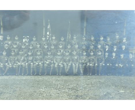 A framed portrait of a Great War Royal Artillery gunner in service dress together with a framed Great War unit photograph of 