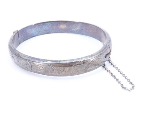 A mid 20th Century silver bangle, having bright cut engraved decoration and hinged with a box catch, Chester, 1958, 15.4 g, 5