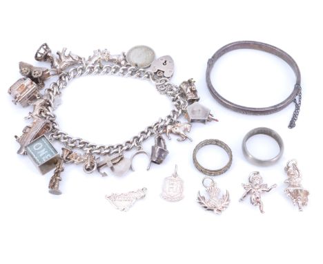 A late 20th Century white metal and electroplate charm bracelet, together with five loose electroplated charms, a white metal