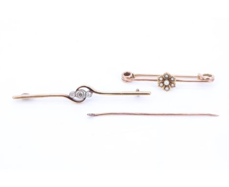 A vintage diamond set yellow metal bar brooch, having a brilliant diamond (approximately 2.5 mm) line set between two eight c