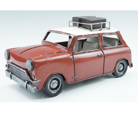 A vintage tinplate model of a Mini, 28 cm long