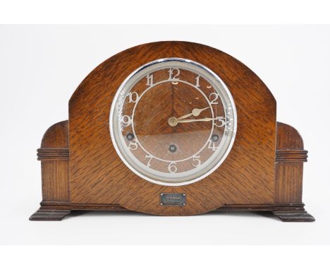 A 1950s oak veneered mantle clock, the movement marked Garrard , 36 cm x 11 cm x 23 cm