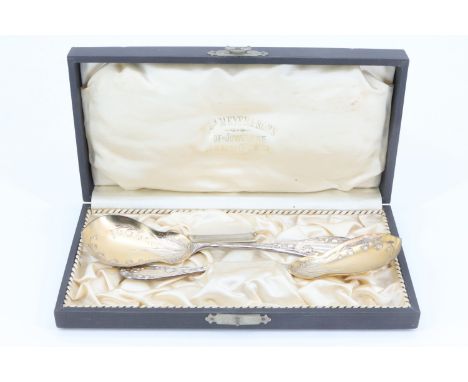 A cased pair of Belle Epoque German silver serving spoons, having pear shaped bowls, decorated with finely cast bluebells, th