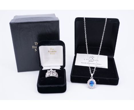 A 'Princess Diana' white metal ring, in the form of a crown set with 10 brilliant pastes and three seed pearls, cased and box