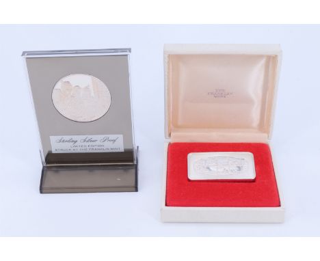 A Franklin Mint 1975 silver "Christmas Ingot", together with a 1974 silver proof "The Christmas Carolers" holiday medal, ingo