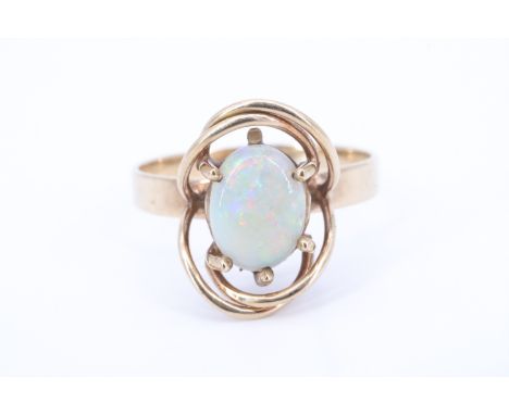 A George VI opal and 9 ct yellow metal ring, the oval opal cabochon transverse set on a crown gallery, within wire openwork, 