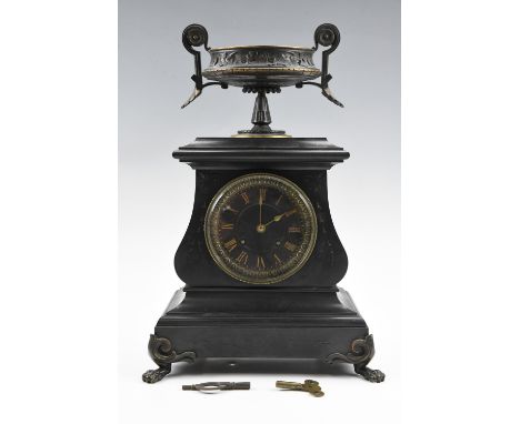 A late 19th Century black slate mantle clock, having a drum movement, the case being of bombé form on a plinth base raised on