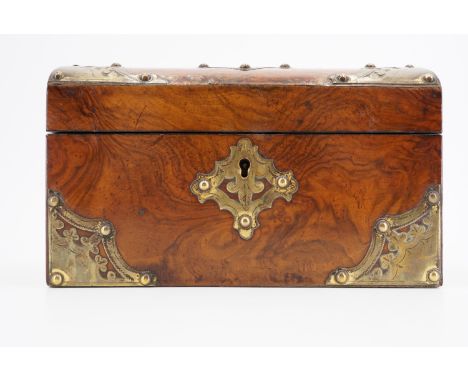 A Victorian dome top walnut veneered two compartment tea caddy, having pierced and engraved brass mounts and a vacant ivory e