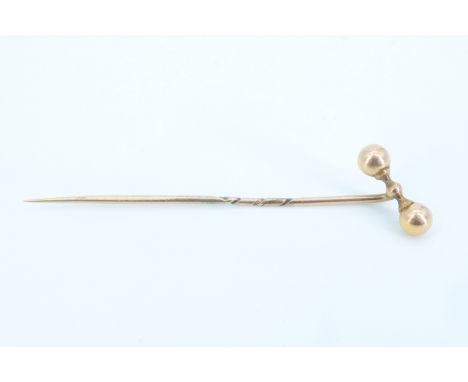 A late 19th / early 20th Century yellow metal stick pin having a barbell terminal, 5.5 cm, 1.0 g