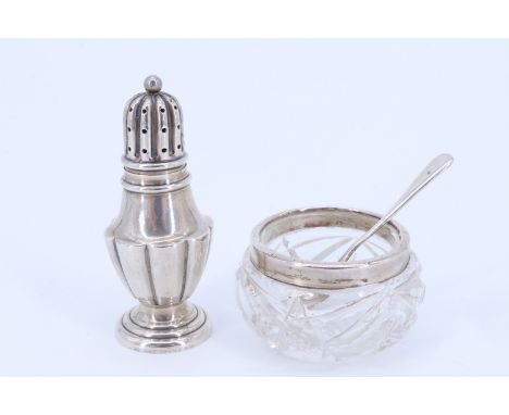 A Victorian silver pepperette, a 1920s silver-collared cut glass salt cellar and a silver salt spoon, tallest 7.5 cm, 22 g ex