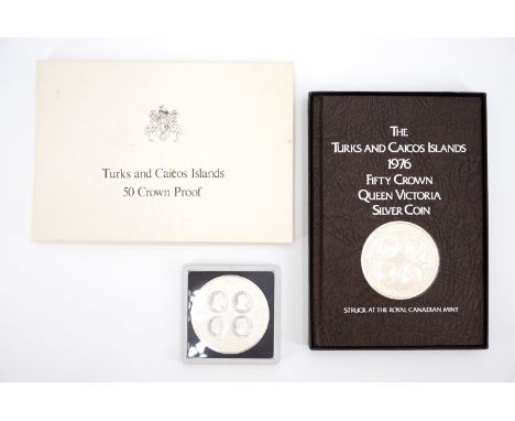 A boxed 1976 silver proof Turks and Caicos Islands 50 Crowns coin and book, together with a 1977 silver proof Turks and Caico