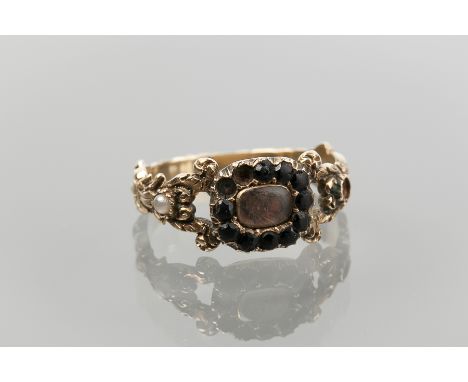 GEORGE IV MOURNING RING
the bezel with central section of woven hair under crystal, surrounded by round sections of jet, on m