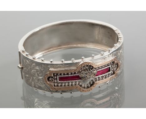VICTORIAN SILVER BANGLE
with scrolling decoration and overlaid in gold, the central crown motif set with diamonds