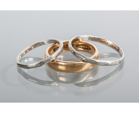 TWO PLATINUM WEDDING BANDS
one size S, misshapen, one size M-N; along with an eighteen carat gold wedding band, size N-O (3)