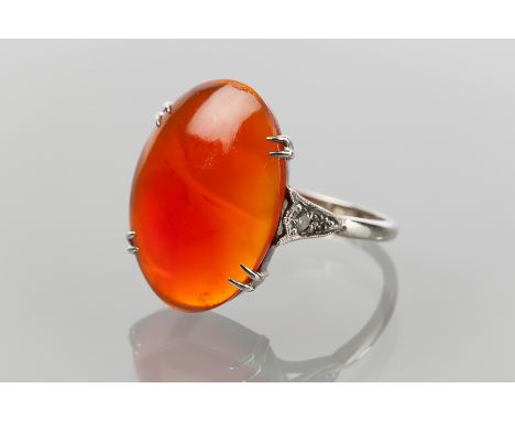 ART DECO PLATINUM RING
set with a large oval red stone, on diamond shoulders, marked PLAT, size O