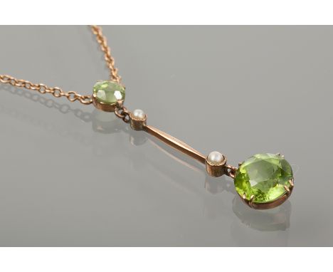 EDWARDIAN PERIDOT AND PEARL NECKLET
with a circular peridot drop below a pearl, suspended from a bar with a further pearl and