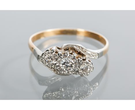DIAMOND THREE STONE RING
set with three brilliant cut diamonds, in a twist setting, in eighteen carat gold and platinum