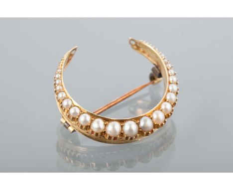 LATE VICTORIAN PEARL SET BROOCH
of crescent shaped form and set with split pearls, 29mm across, unmarked, 5g