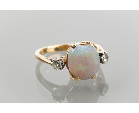 EDWARDIAN OPAL AND DIAMOND THREE STONE RING
the large opal with significant wear flanked by two round diamonds, hallmarks wor