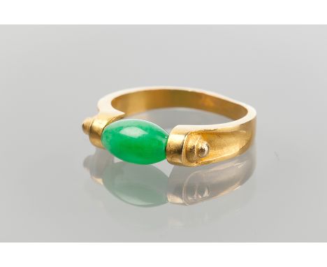 UNUSUAL JADEITE RING 
set with a green jadeite bead, in unmarked high carat gold, size N