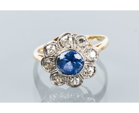 SAPPHIRE AND DIAMOND CLUSTER RING
with a central round sapphire surrounded by eight diamonds, unmarked, size F-G