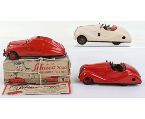 Three early Schuco Tinplate Toy Cars, Examico 4001, cream/red interior, Akustico 2002 red/maroon seats, both missing windscre