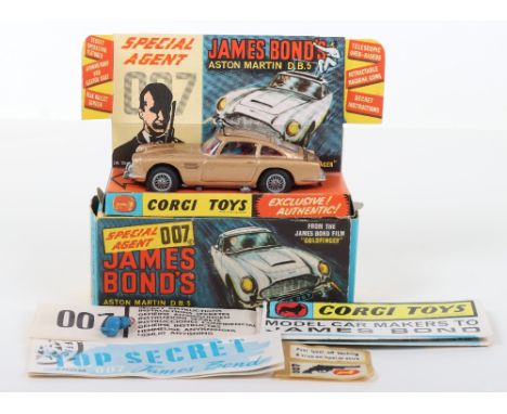 Corgi Toys 261 James Bond Aston Martin D.B.5 from the Film “Goldfinger” gold body, with ejector seat, rear bullet screen, ret