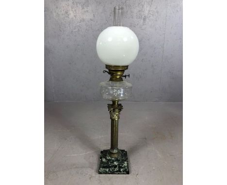 Large oil lamp on stepped marble plinth, with brass Corinthian column supporting etched clear glass reservoir topped by funne