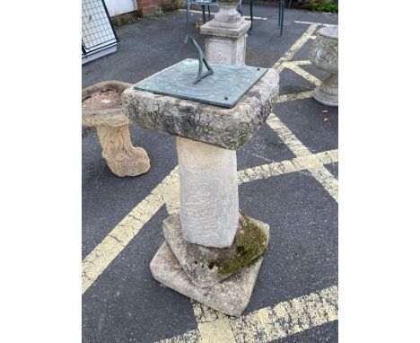 Concrete garden sundial with metal sundial