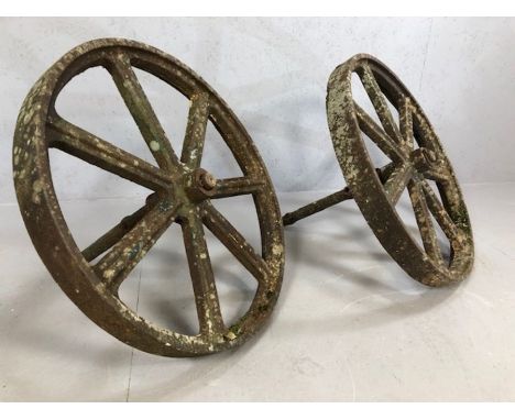 Pair of seven spoke vintage cast iron cartwheels with axels, approx 75cm in diameter