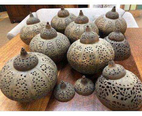 Collection of Eastern pierced brass pendant light shades, seven large cylindrical shades and two smaller open shades, 9 in to