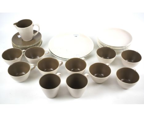 A box containing a 1950s Poole twin-tone part tea service. Glazed in brown and cream, marked 'C54'