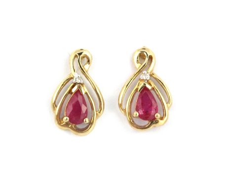 A pair of 9ct yellow gold ruby and diamond set stud earrings, L. 1.2cm