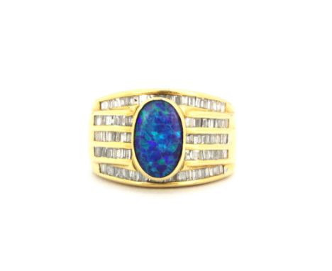 A heavy gentleman's 18ct yellow gold (stamped 18k) ring set with an opal triplet and baguette cut diamonds, (L).