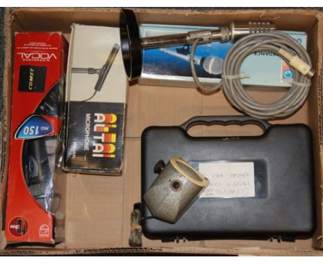 A box of vintage microphones including a vintage German desk microphone.