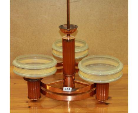 An Art Deco copper three branch ceiling light fitting with three glass shades, W. 55cm H. 58cm.