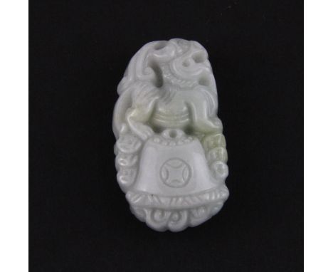 A finely carved Chinese jadeite jade amulet of a young dragon with cash, H. 4cm.