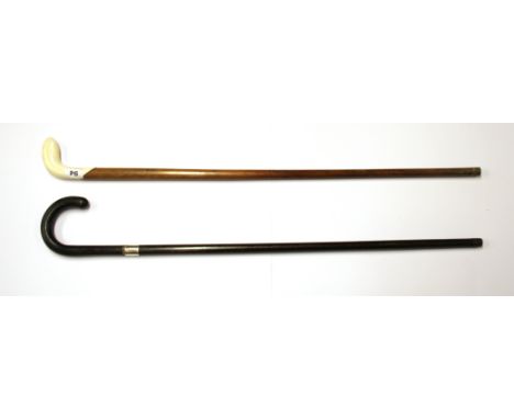 A hallmarked silver mounted walking stick and a further antique walking stick with a marine ivory handle.